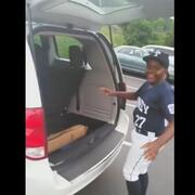Boy opening minivan hatch