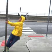 Woman holding on to sign in high winds